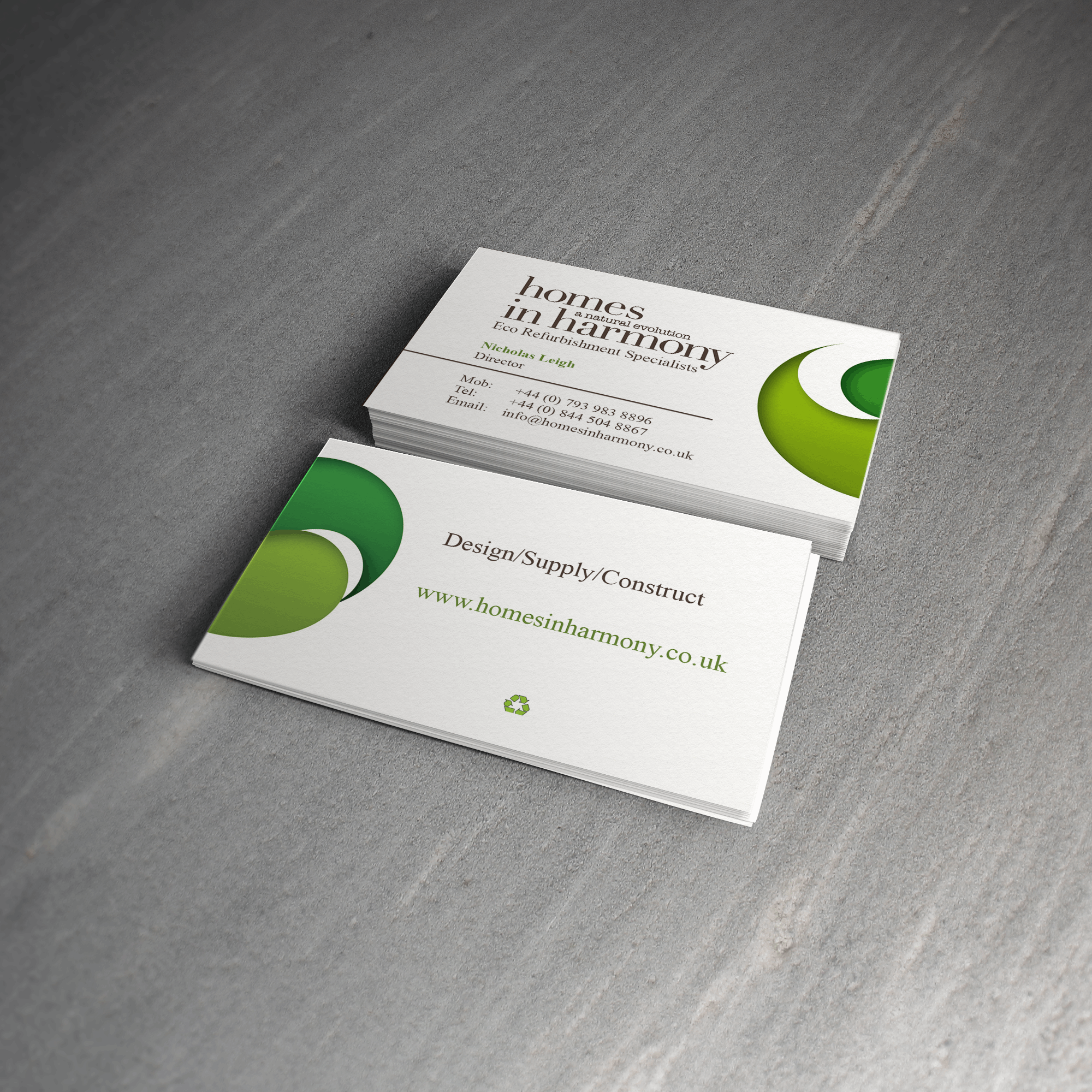 Homes in Harmony business cards stacked showing front and back